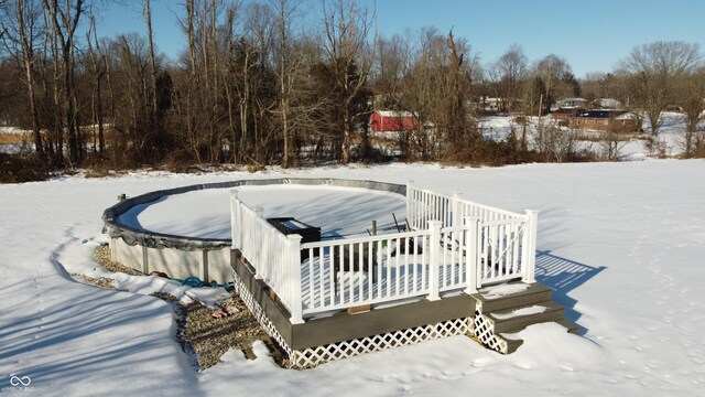 snow covered deck with a covered pool