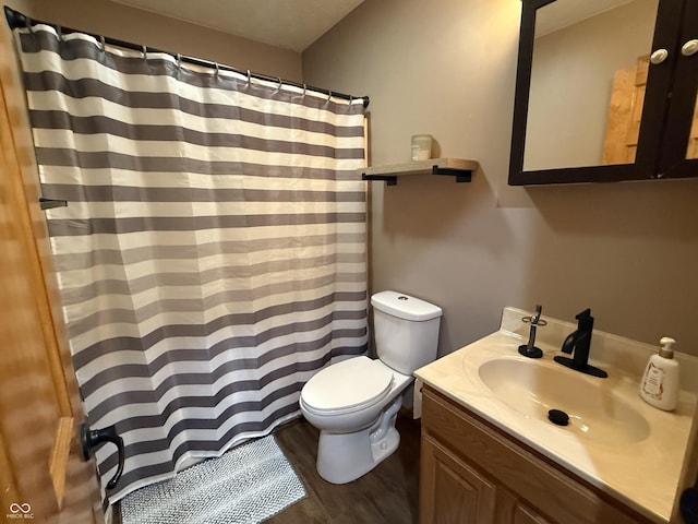 bathroom with vanity, hardwood / wood-style floors, and toilet