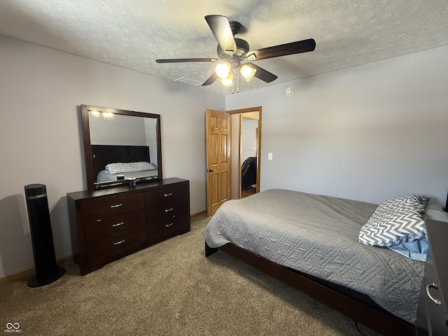 bedroom with light carpet, ceiling fan, and a textured ceiling