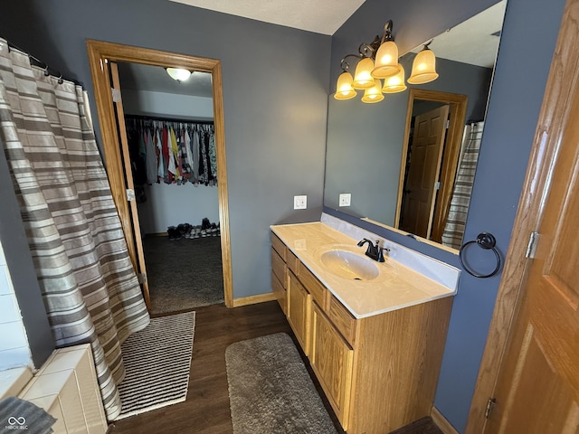 bathroom with vanity, hardwood / wood-style floors, and a notable chandelier