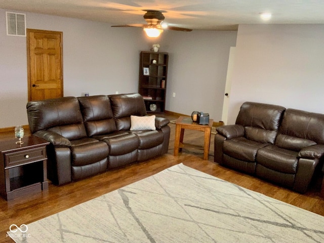 living room with ceiling fan and wood-type flooring