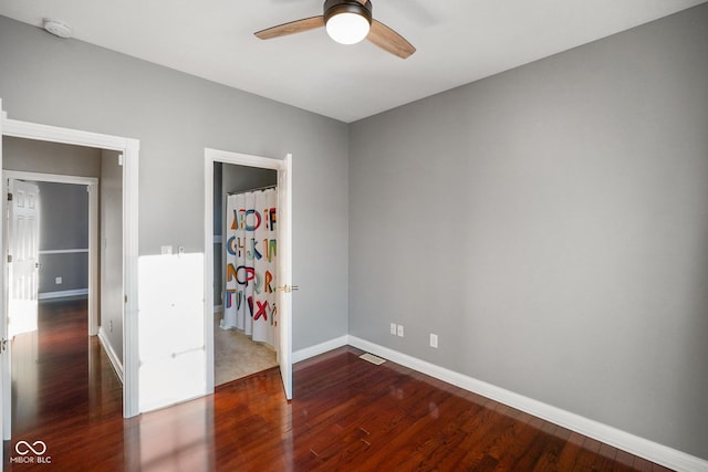 unfurnished bedroom with ceiling fan and dark hardwood / wood-style flooring