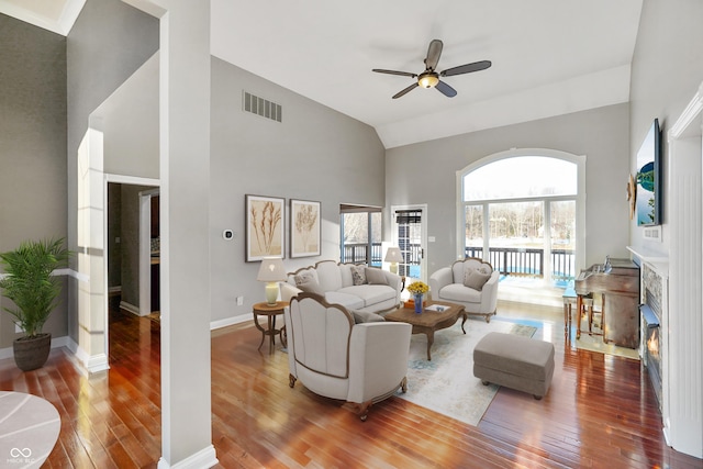 living room featuring ceiling fan, high vaulted ceiling, and hardwood / wood-style floors