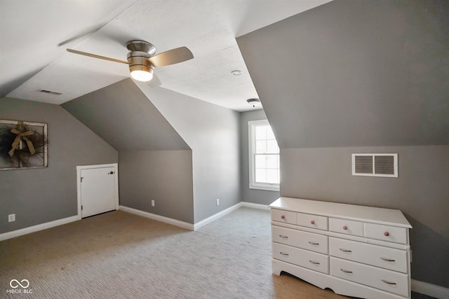 additional living space with light carpet, lofted ceiling, and ceiling fan