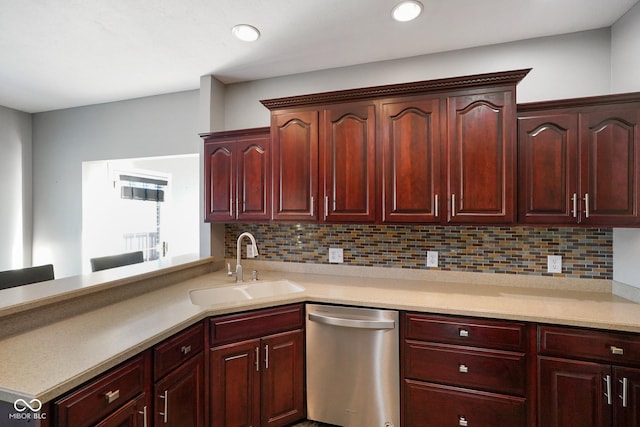 kitchen with tasteful backsplash, sink, and stainless steel dishwasher