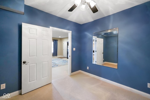 unfurnished room with ceiling fan and carpet floors