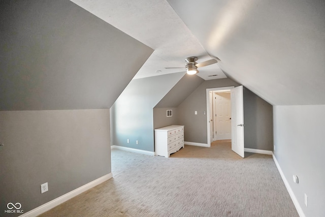 additional living space with lofted ceiling, light carpet, and ceiling fan