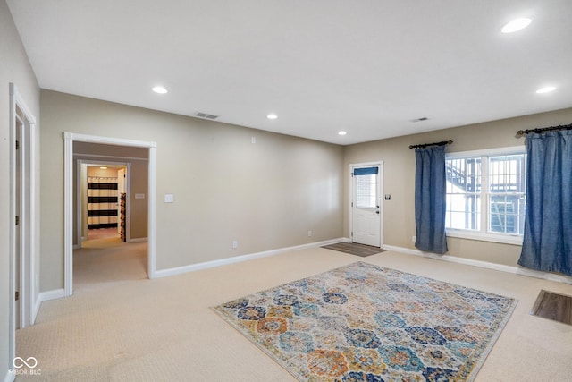 foyer entrance featuring light carpet