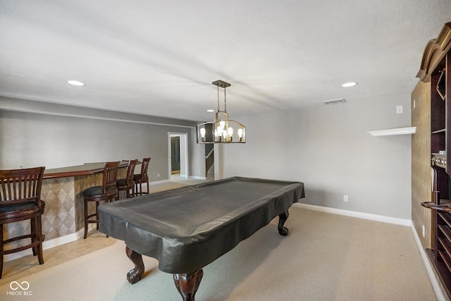 recreation room with light carpet, bar, and pool table