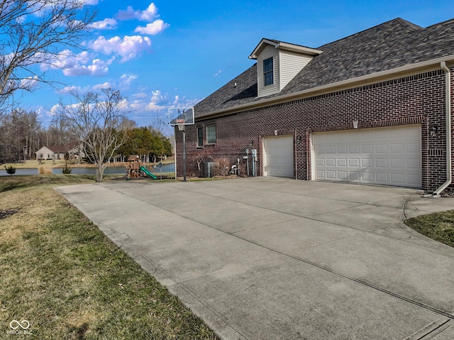 view of side of home with a playground and a garage