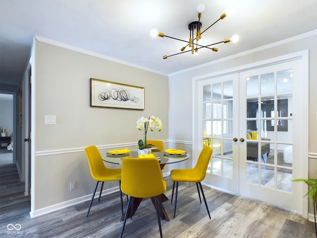 dining area featuring a notable chandelier, french doors, crown molding, and wood-type flooring