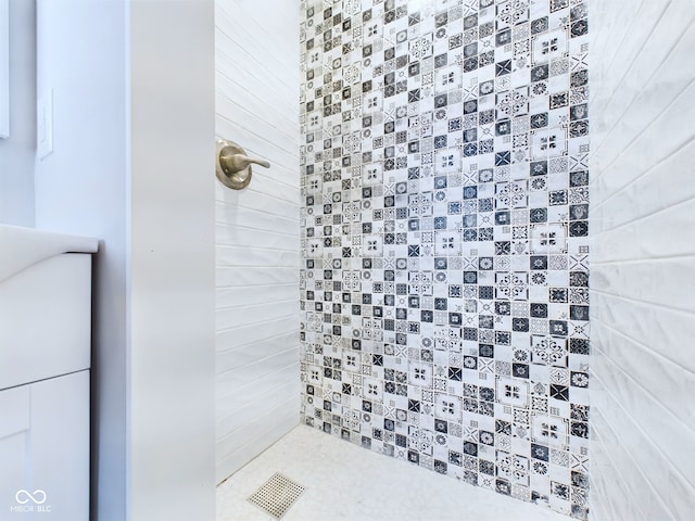 bathroom with tiled shower