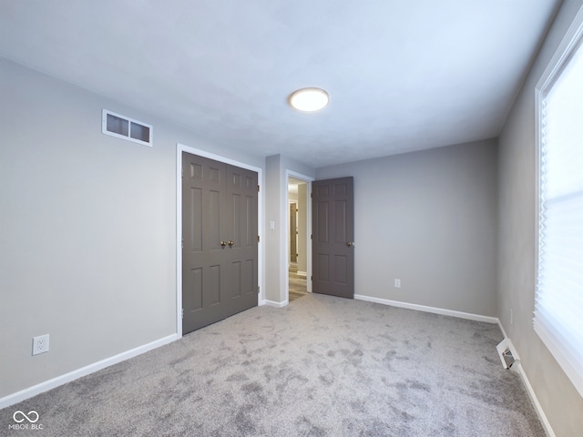 unfurnished bedroom with a closet and carpet