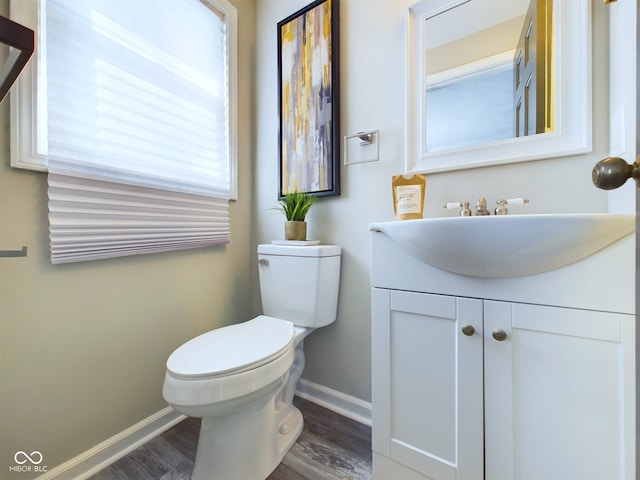 bathroom featuring vanity, toilet, and hardwood / wood-style flooring