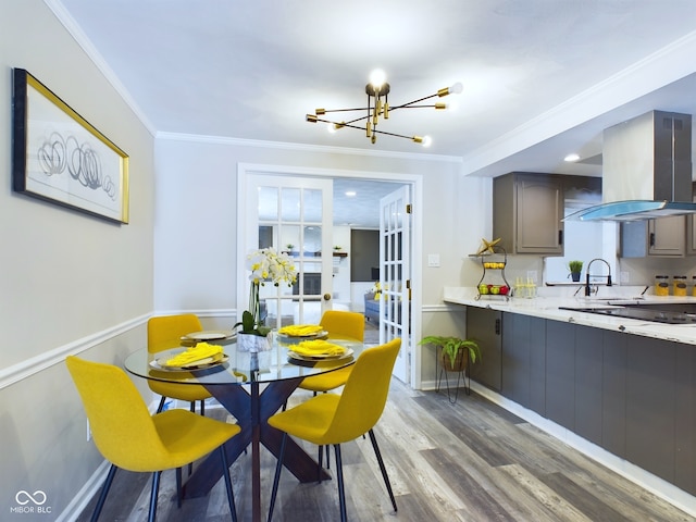 dining room with hardwood / wood-style floors, french doors, a chandelier, and ornamental molding