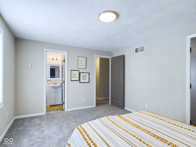 unfurnished bedroom with light colored carpet and ensuite bath