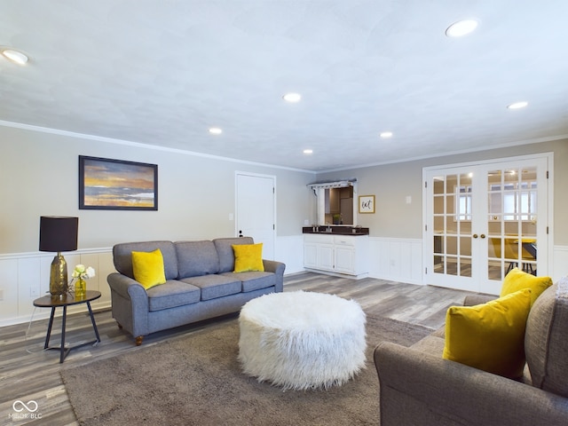 living room featuring french doors, crown molding, and hardwood / wood-style floors