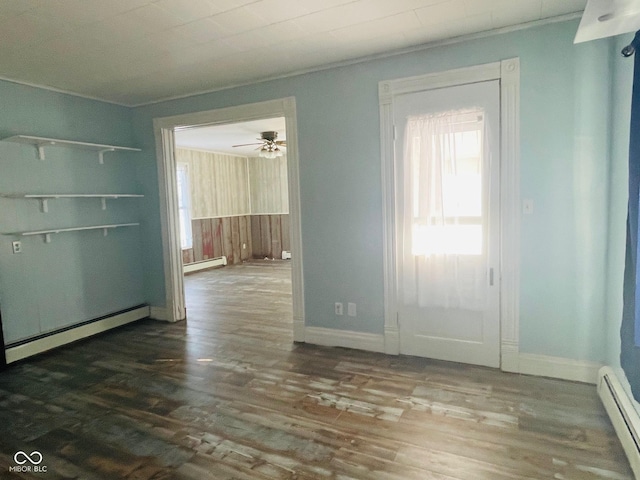 empty room featuring ceiling fan, hardwood / wood-style floors, and a baseboard radiator