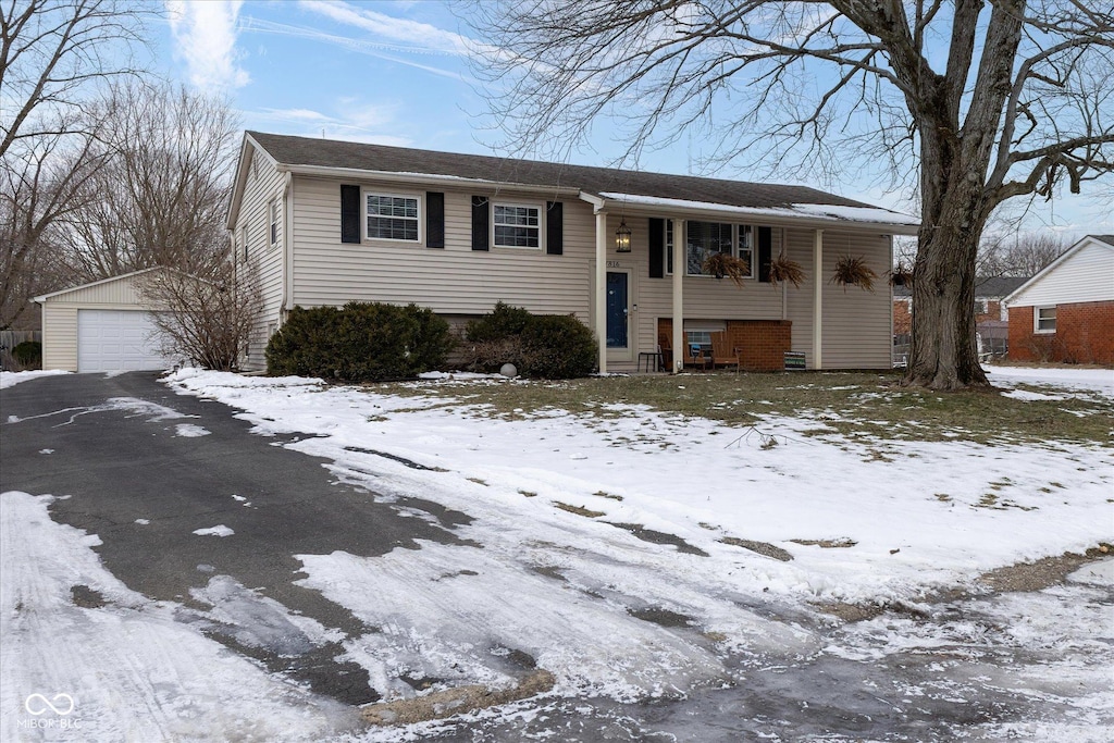 split foyer home with a garage and an outbuilding