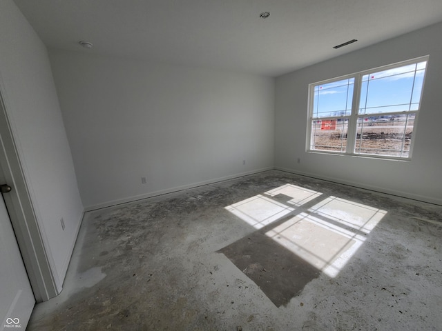 unfurnished room with concrete flooring