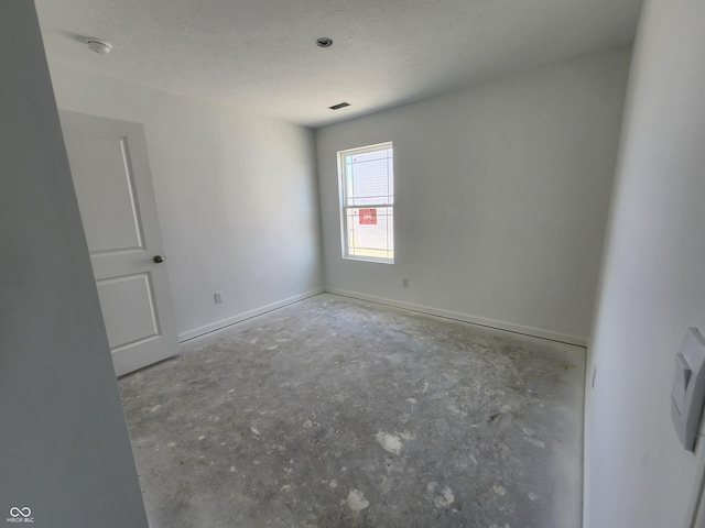 empty room featuring a textured ceiling