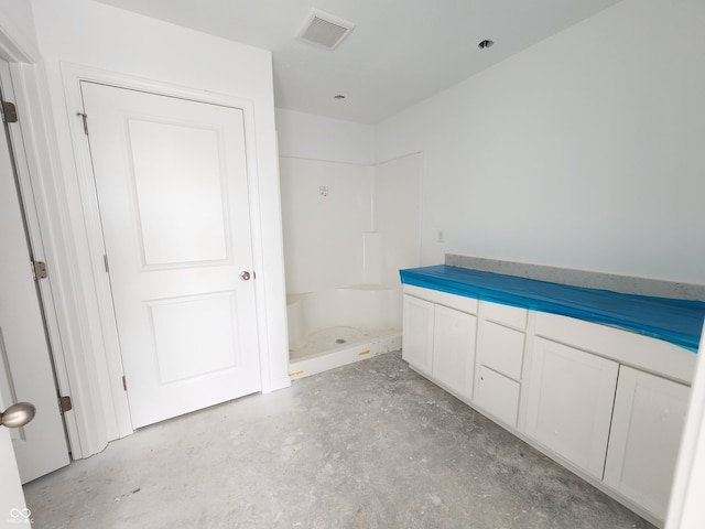 full bath featuring a stall shower, visible vents, and concrete flooring