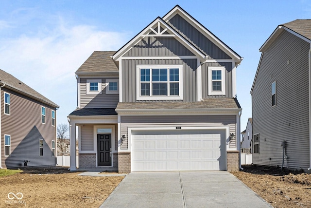 craftsman inspired home featuring an attached garage, concrete driveway, board and batten siding, and brick siding