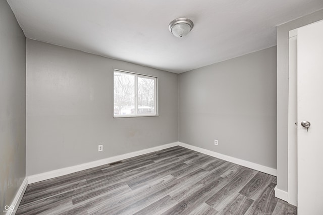 spare room with dark hardwood / wood-style flooring