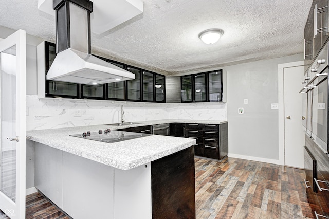 kitchen featuring stainless steel oven, kitchen peninsula, backsplash, and black electric cooktop