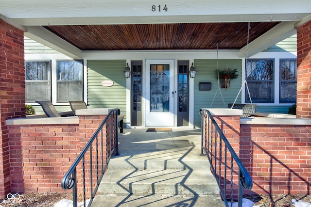 view of exterior entry with covered porch