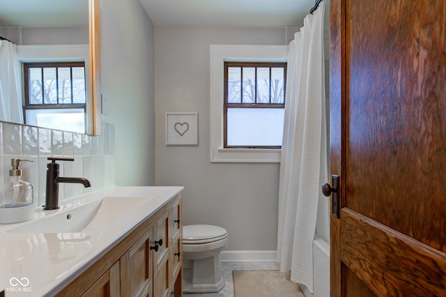 full bathroom with toilet, vanity, tile patterned floors, shower / tub combo, and decorative backsplash