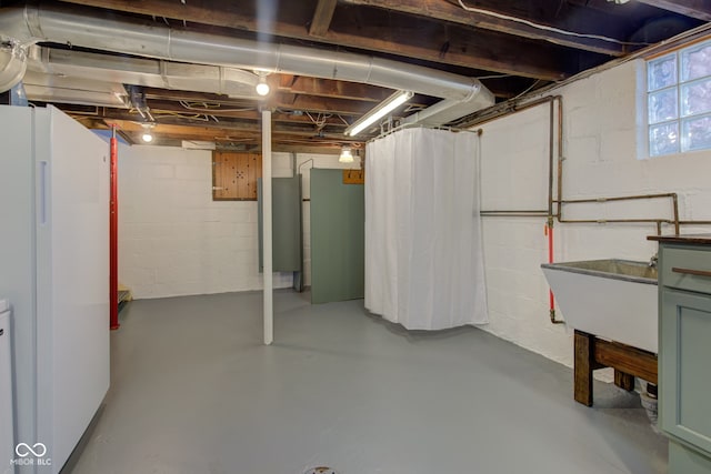 basement with white fridge