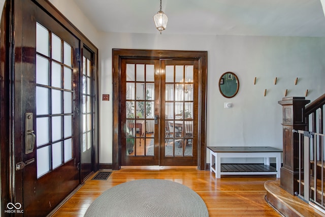 doorway with light wood-type flooring and french doors