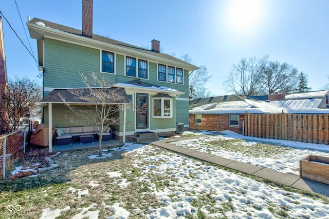 view of snow covered rear of property