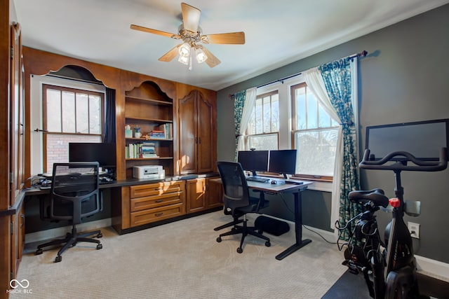 carpeted office featuring ceiling fan