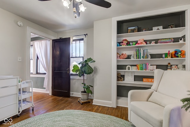 living area with ceiling fan and wood-type flooring