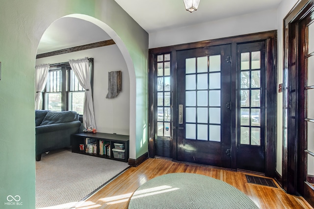 foyer entrance featuring french doors and hardwood / wood-style floors