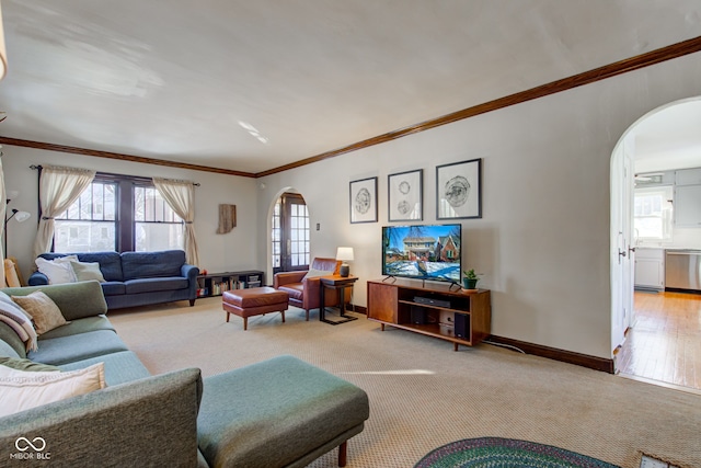 living room with light carpet, a healthy amount of sunlight, and crown molding