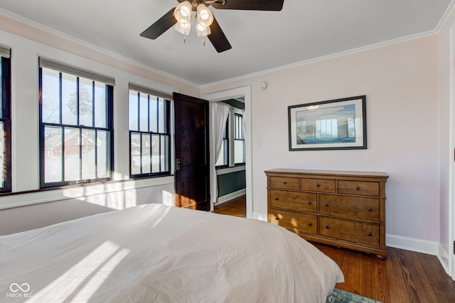 bedroom with ceiling fan, dark hardwood / wood-style flooring, and crown molding