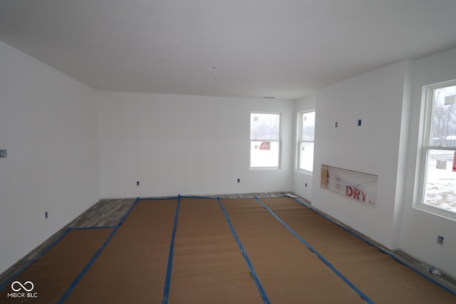 empty room with a healthy amount of sunlight and basketball hoop