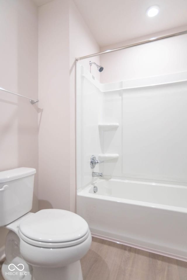 bathroom featuring toilet, bathtub / shower combination, and hardwood / wood-style flooring