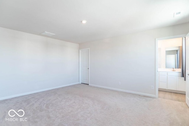 empty room with light colored carpet and sink