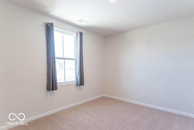 carpeted empty room featuring a healthy amount of sunlight