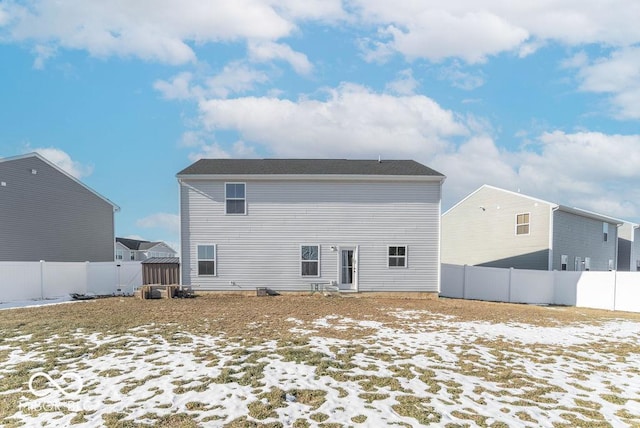 view of snow covered rear of property