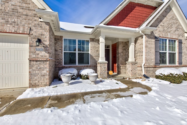 view of snow covered property entrance