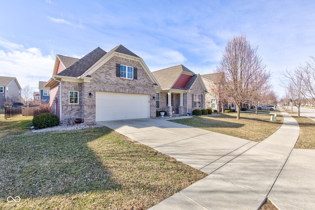 view of front facade with a front yard, fence, roof with shingles, an attached garage, and concrete driveway