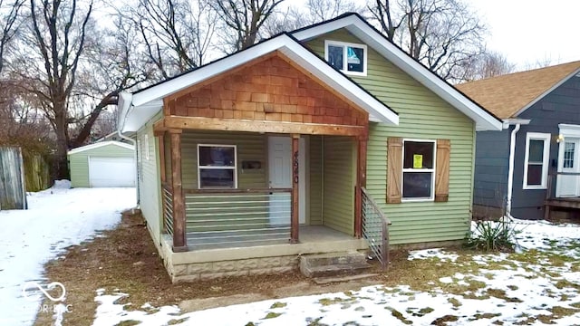 view of front of house with a garage and an outdoor structure