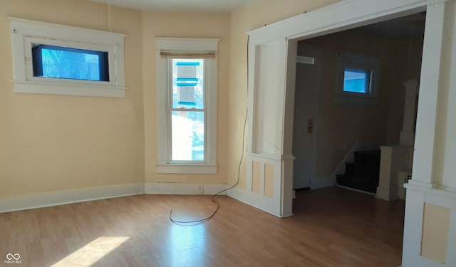 unfurnished room featuring hardwood / wood-style flooring