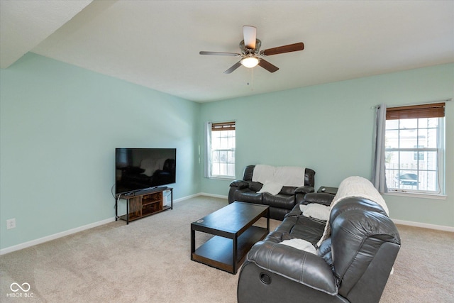 living room featuring ceiling fan, light colored carpet, and plenty of natural light