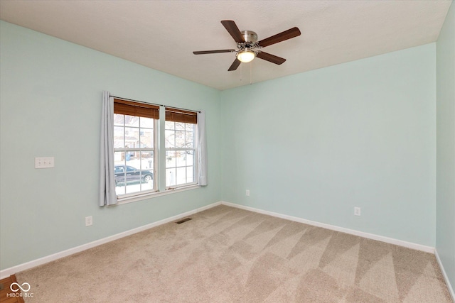 spare room featuring carpet floors and ceiling fan